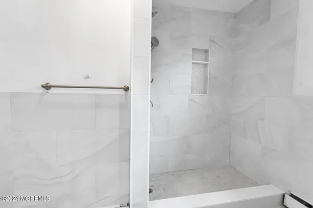 a bathroom with a glass shower door
