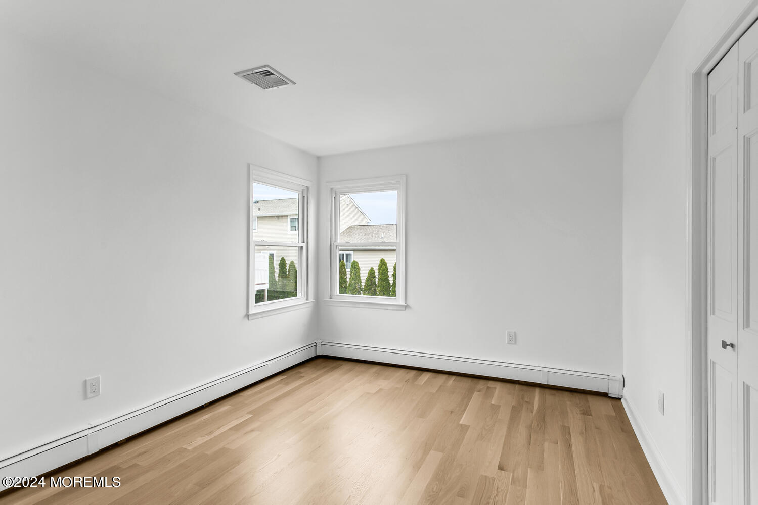 74 Ward Avenue Rumson, NJ 07760 - Photo 21 of 23 an empty room with wooden floor and windows
