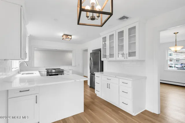a kitchen with stainless steel appliances granite countertop a stove and a refrigerator