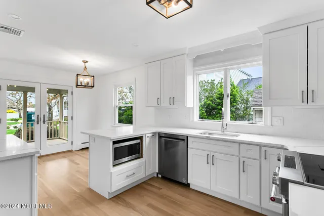 a kitchen with a white stove top oven sink and window