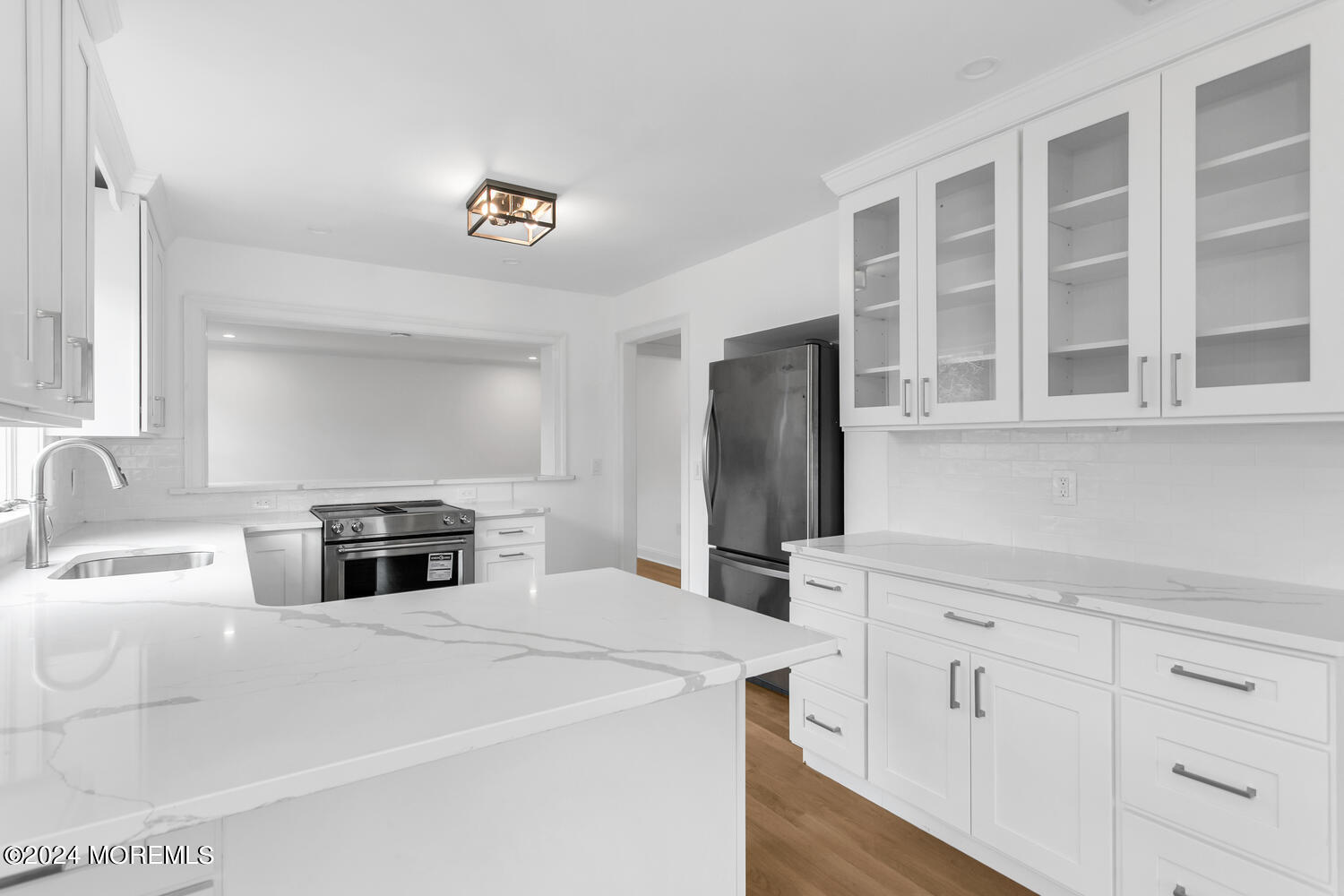 74 Ward Avenue Rumson, NJ 07760 - Photo 6 of 23 a kitchen with stainless steel appliances a stove a sink and a refrigerator