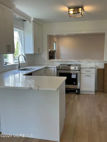 a kitchen with a stove a sink and a refrigerator
