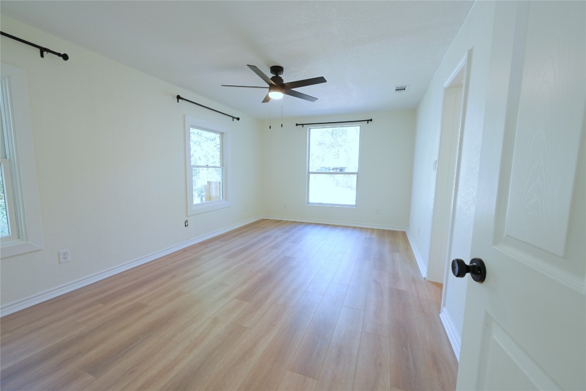 2311 South 3rd Street Austin, TX 78704 - Photo 4 of 14 a view of an empty room with a window and wooden floor