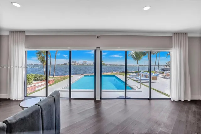 a living room with furniture and a floor to ceiling window