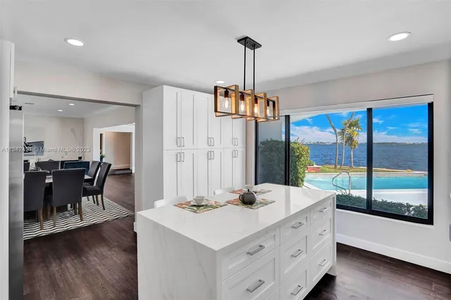 a view of dining room and livingroom with furniture wooden floor a chandelier