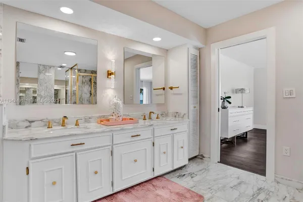 a bathroom with a double vanity sink mirror and double