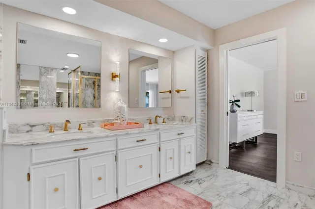a bathroom with a double vanity sink mirror and double