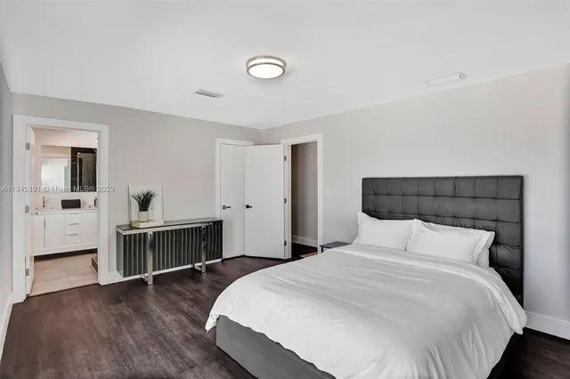 a bedroom with a bed and a desk