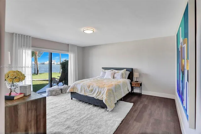 a bedroom with a bed and large windows