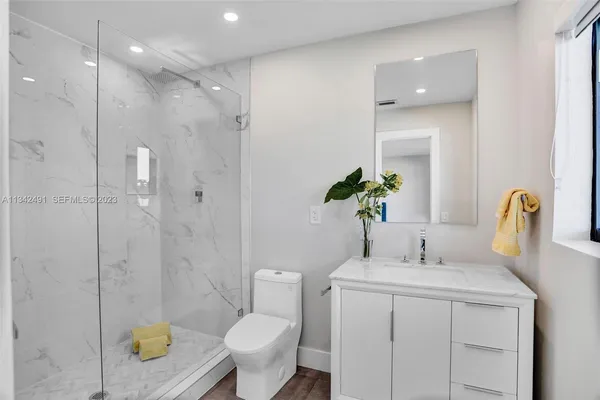 a bathroom with a sink toilet and shower