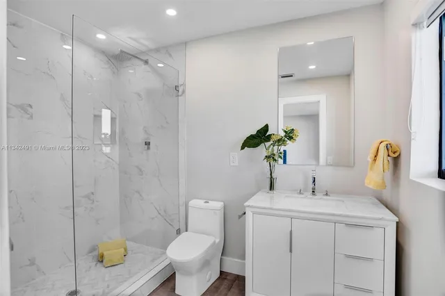 a bathroom with a sink toilet and shower