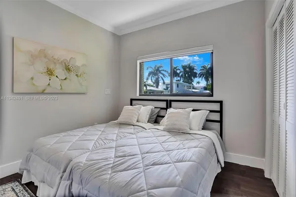 a large bed in a white room