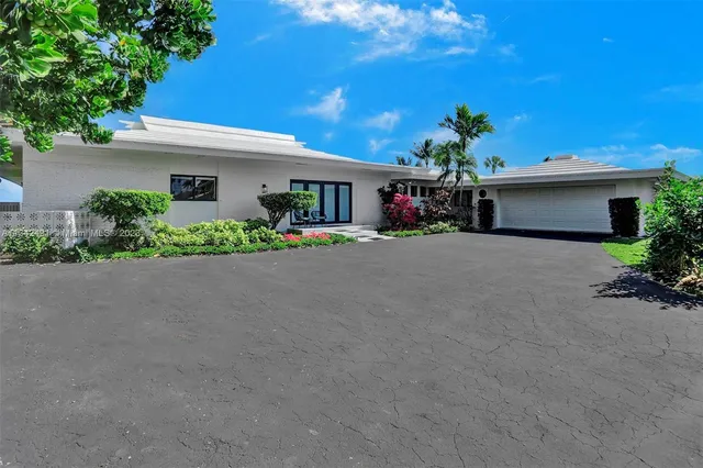 a front view of a house with a yard and a garage
