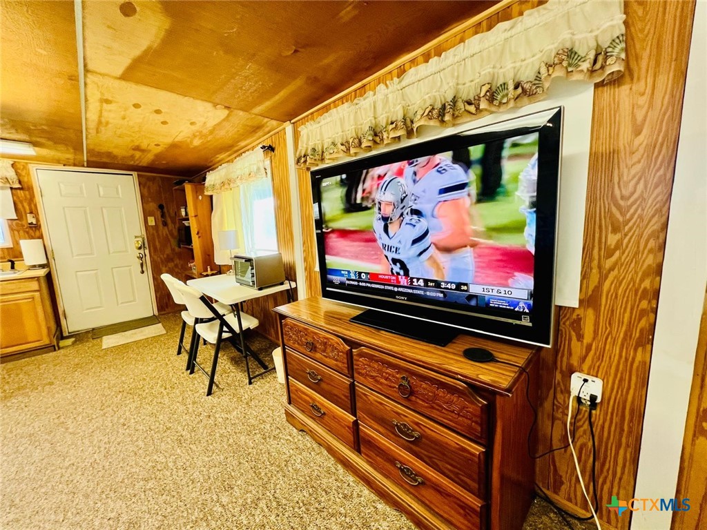 56 Rutherford Street Port O'Connor, TX 77982 - Photo 11 of 37 a living room with furniture and a flat screen tv