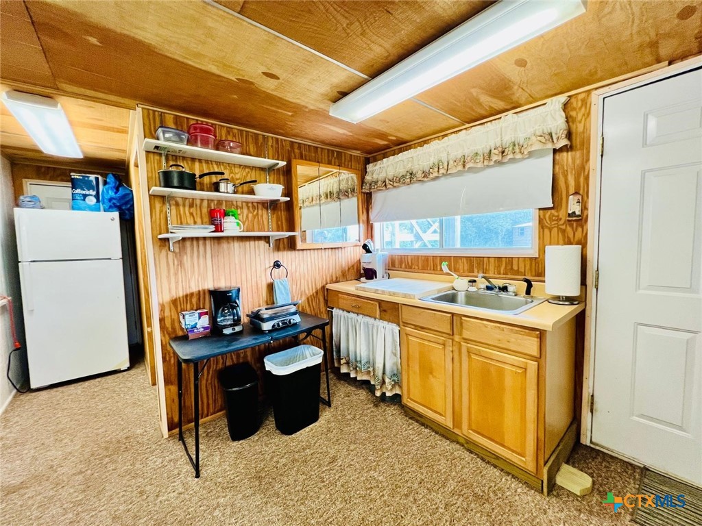 56 Rutherford Street Port O'Connor, TX 77982 - Photo 12 of 37 a kitchen with a sink appliances and cabinets