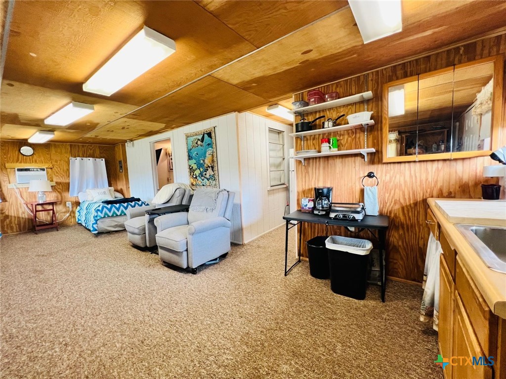 56 Rutherford Street Port O'Connor, TX 77982 - Photo 2 of 37 a living room with furniture and a flat screen tv