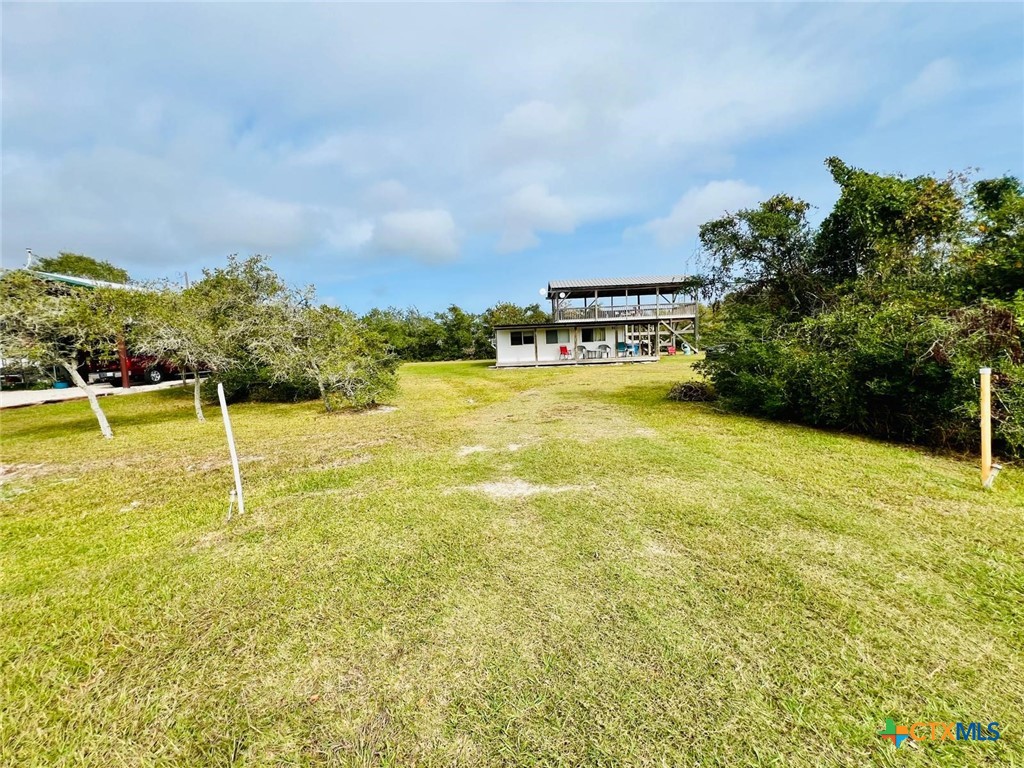 56 Rutherford Street Port O'Connor, TX 77982 - Photo 26 of 37 a view of a swimming pool with an outdoor seating and yard