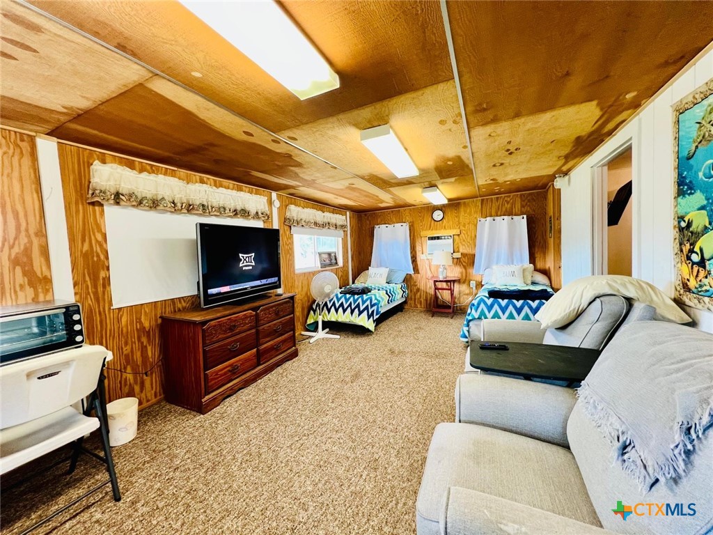 56 Rutherford Street Port O'Connor, TX 77982 - Photo 4 of 37 a living room with furniture and a flat screen tv