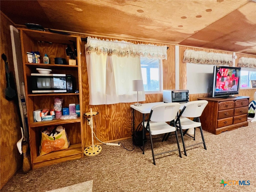 56 Rutherford Street Port O'Connor, TX 77982 - Photo 5 of 37 a dining room with furniture and a window