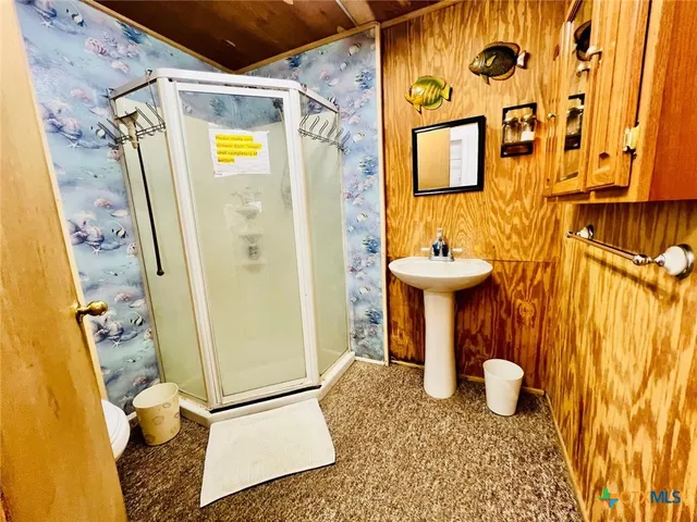 a bathroom with a toilet and shower