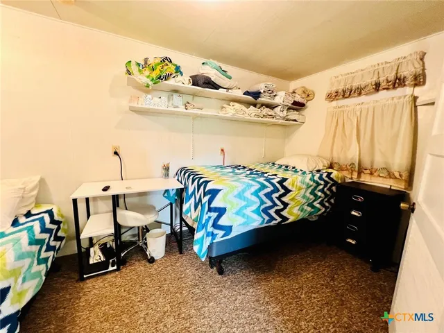 a bedroom with a bed and a lamp