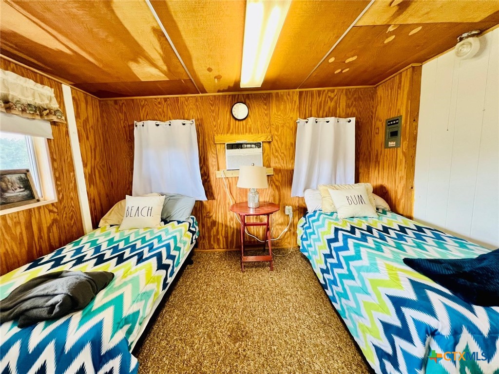 56 Rutherford Street Port O'Connor, TX 77982 - Photo 10 of 37 a bedroom with a bed and wooden floor