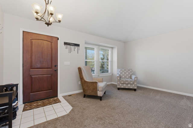 11189 Ohenry Road East Sandy, UT 84070 - Photo 4 of 44 Entryway featuring a paneled wood-finish door, overhead chandelier, and white tile flooring