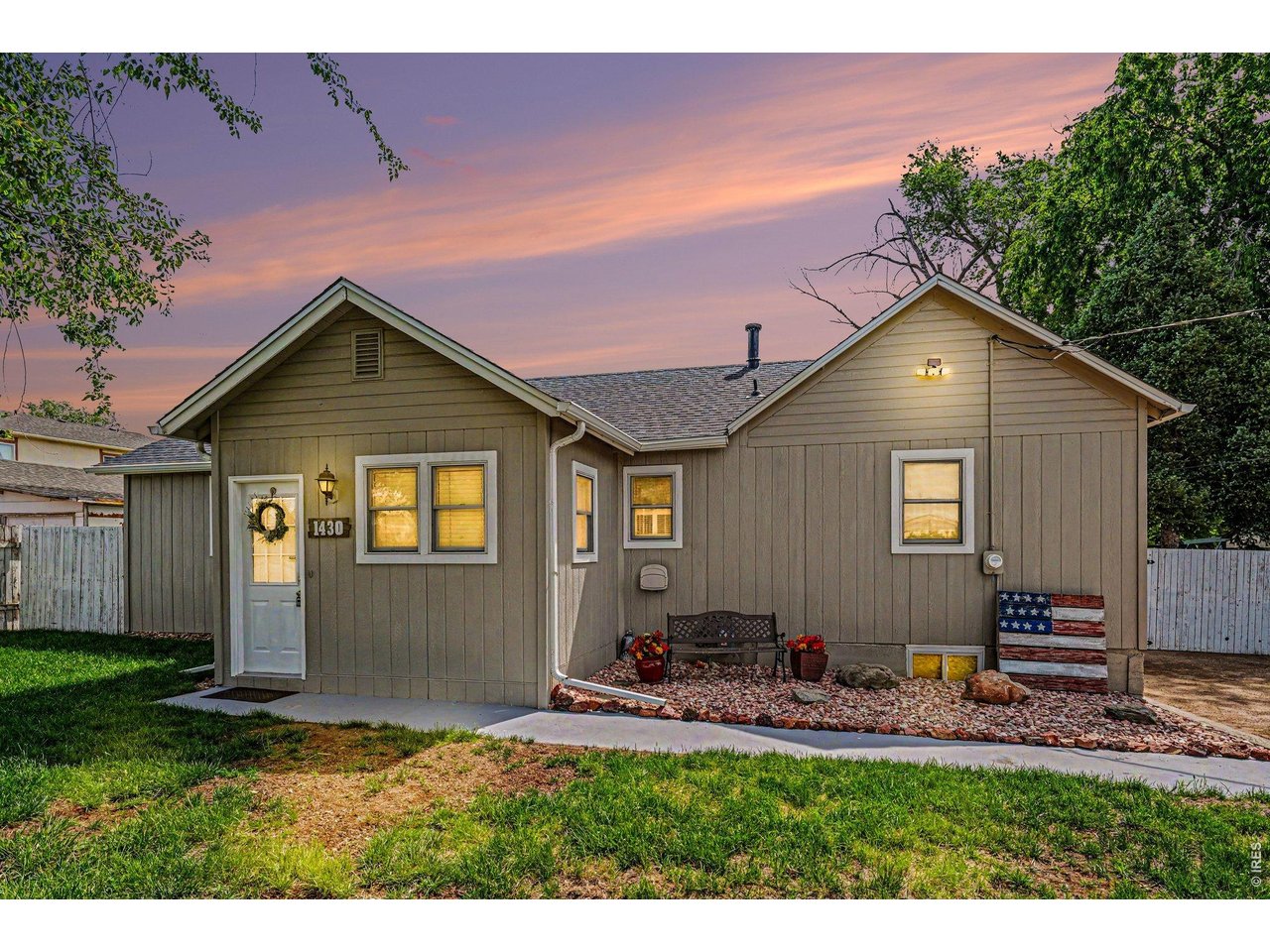 1430 30th Street Road Greeley, CO 80631 - Photo 1 of 22 a front view of a house with a yard and garage