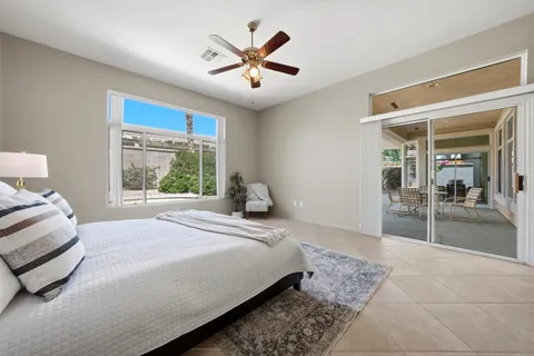a bedroom with a large bed and a large window
