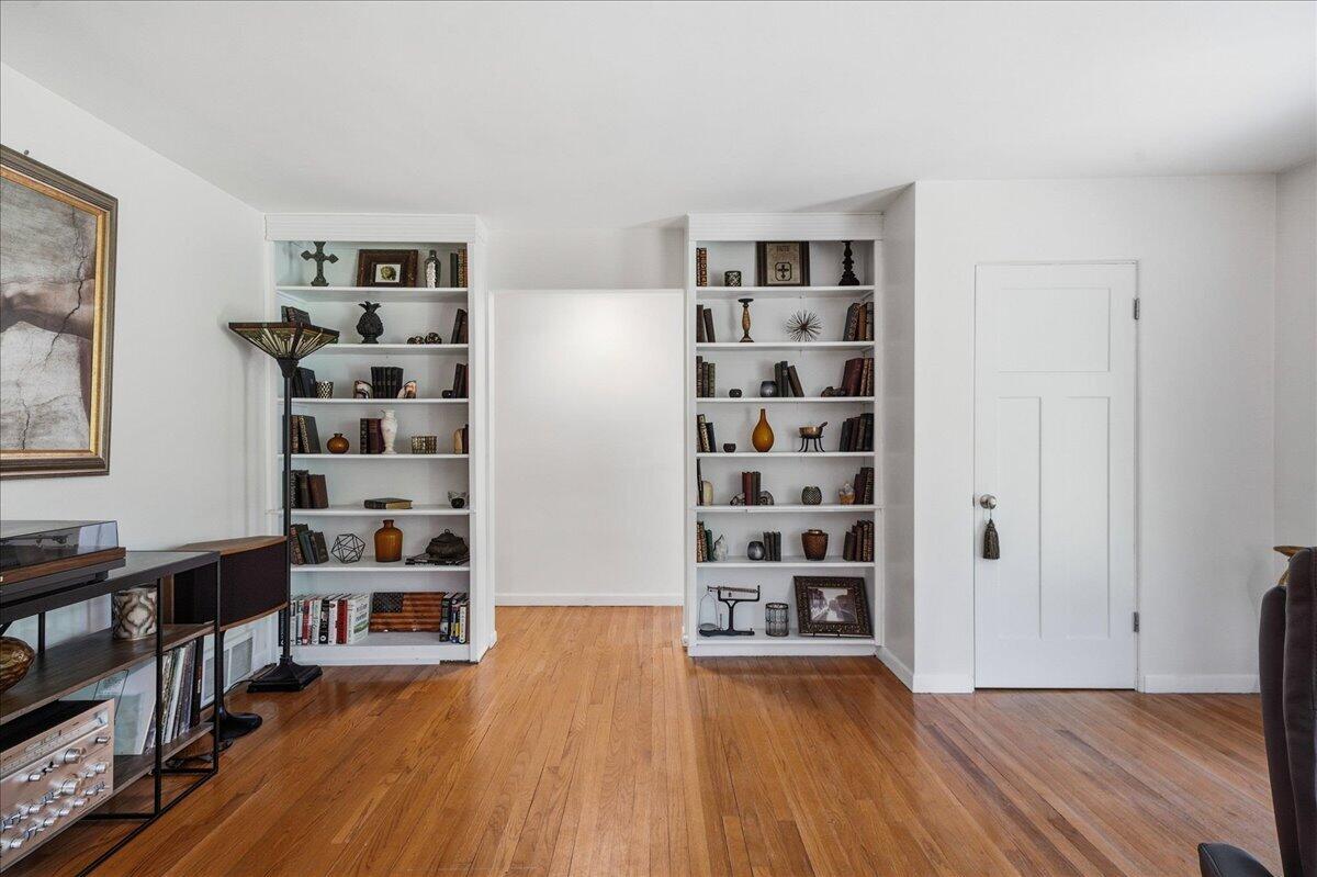 63 Ski Hill Road Portage, IN 46368 - Photo 10 of 28 a view of a livingroom with wooden floor and shelves
