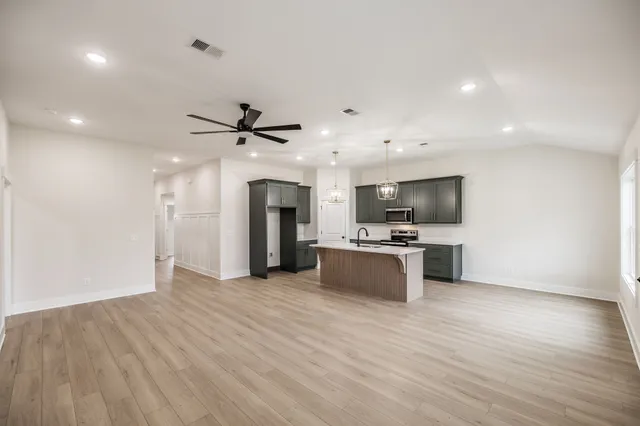 a view of kitchen with sink microwave and refrigerator