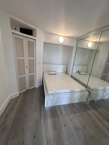 a room with a wooden floor and entryway