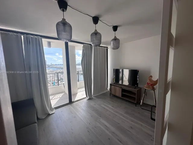 a view of a livingroom with hardwood floor and a ceiling fan