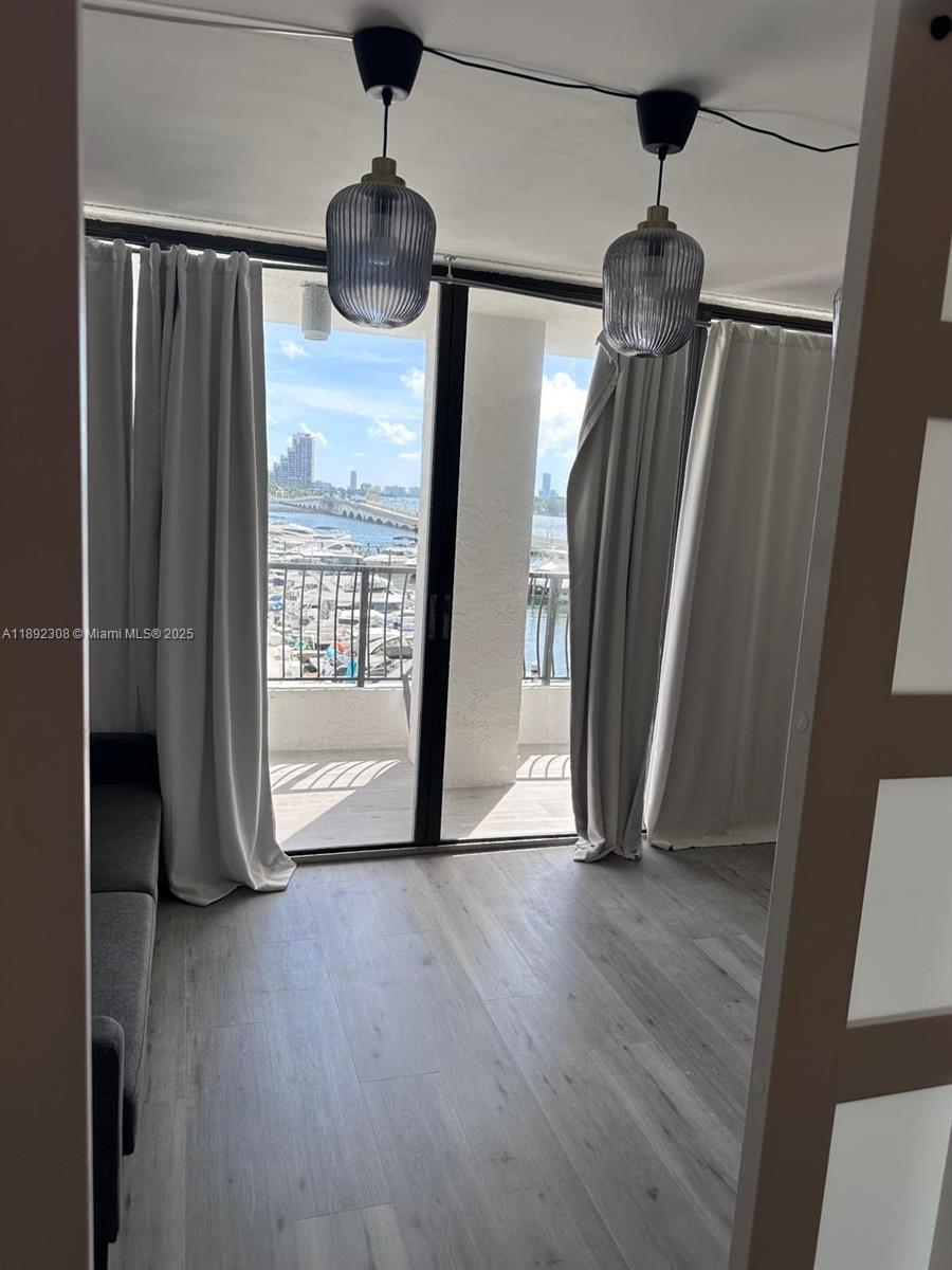 555 Northeast 15th Street, Unit 416 Miami, FL 33132 - Photo 2 of 13 a view of empty room with wooden floor and fan