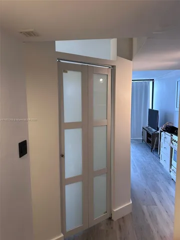 a view of a livingroom with wooden floor and furniture