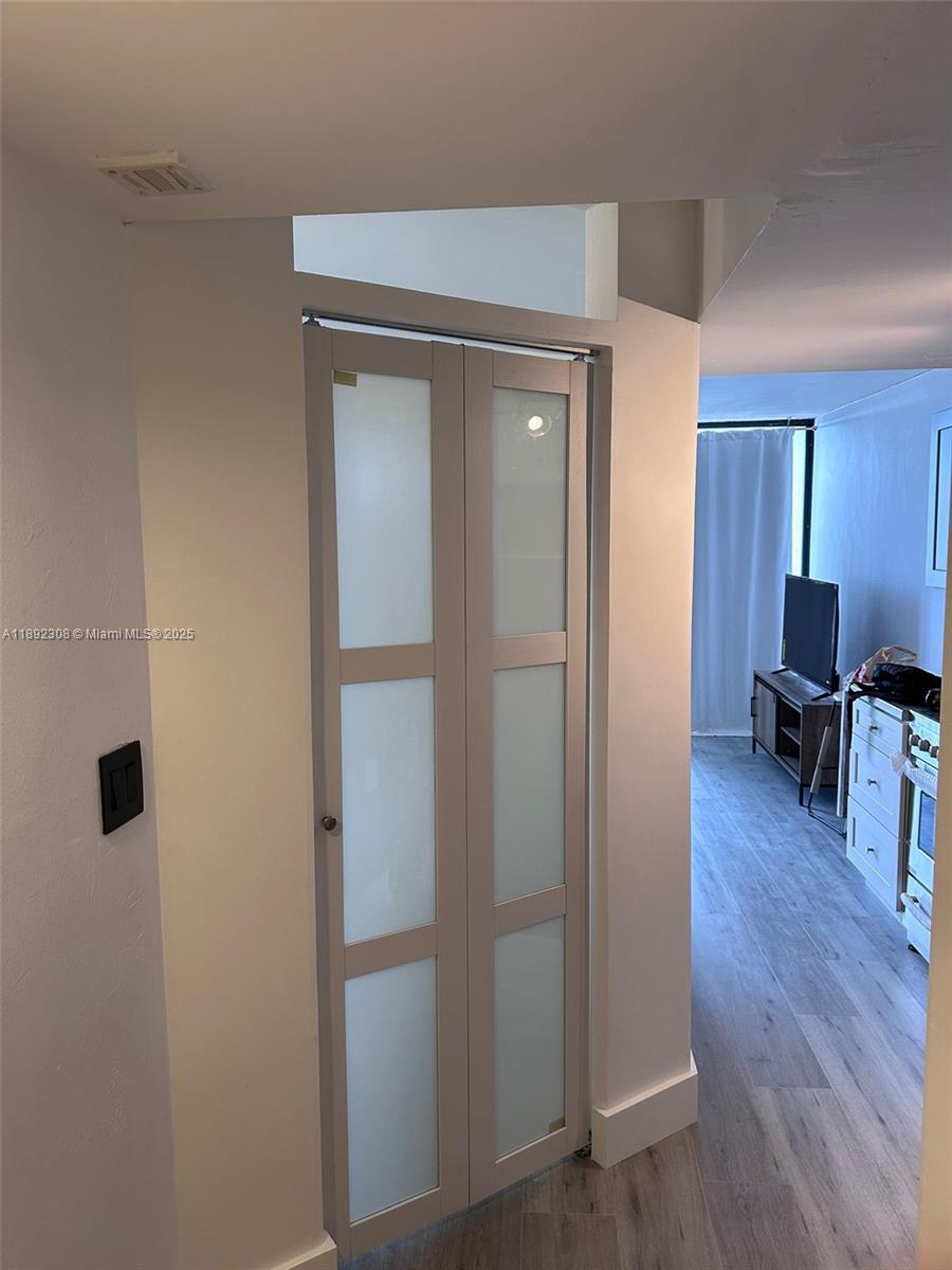 555 Northeast 15th Street, Unit 416 Miami, FL 33132 - Photo 6 of 13 a view of a livingroom with wooden floor and furniture