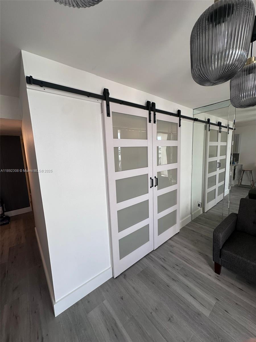 555 Northeast 15th Street, Unit 416 Miami, FL 33132 - Photo 10 of 13 a view of an empty room with wooden floor and a window
