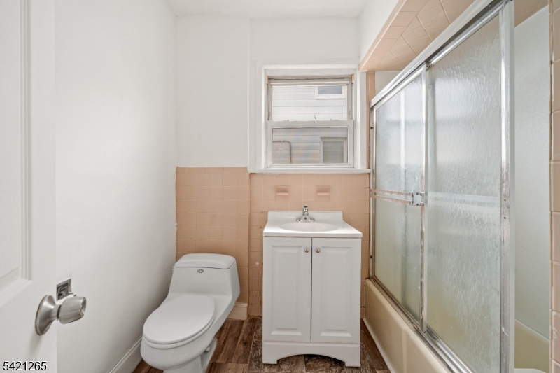 116 Berkeley Avenue Bloomfield, NJ 07003 - Photo 11 of 13 a bathroom with a toilet a sink and shower