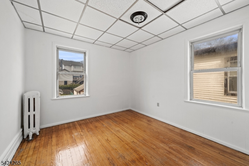 116 Berkeley Avenue Bloomfield, NJ 07003 - Photo 7 of 13 an empty room with windows