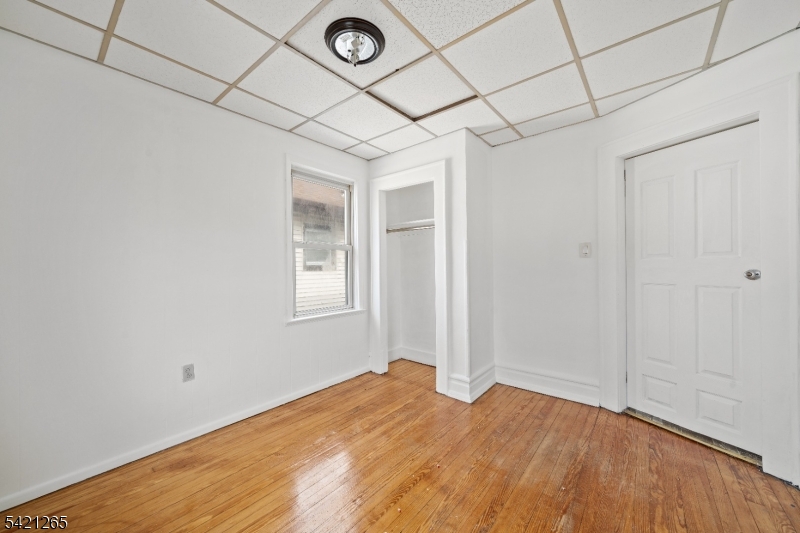 116 Berkeley Avenue Bloomfield, NJ 07003 - Photo 9 of 13 a view of empty room with wooden floor