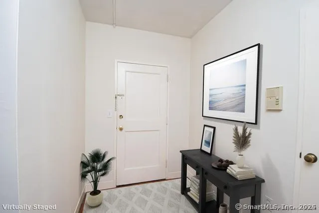 a living room with furniture and a potted plant