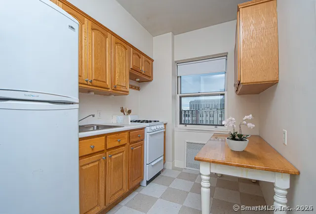a kitchen with stainless steel appliances granite countertop a sink and a stove