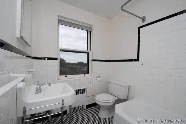 a white toilet sitting next to a bathroom sink