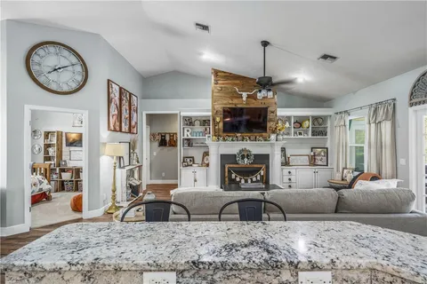 a living room with furniture a flat screen tv and a fireplace