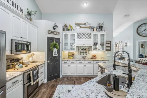a kitchen with stainless steel appliances granite countertop a sink and cabinets