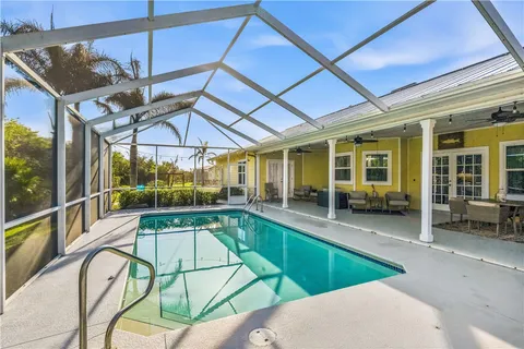 a swimming pool with patio outdoor seating and yard