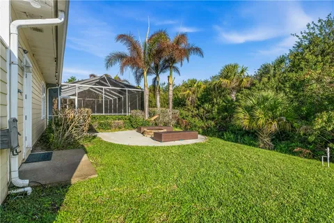 a view of a backyard with plants and a patio