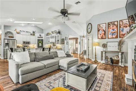 a living room with furniture and a chandelier