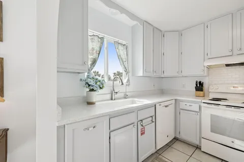 a kitchen with a sink cabinets and window