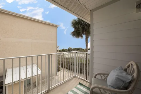 a balcony with wooden floor and city view